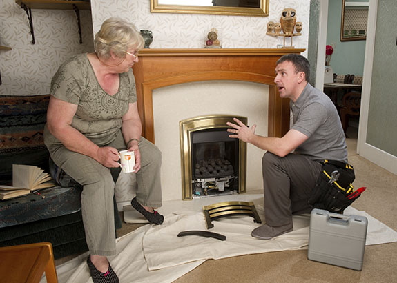 man helping woman with fireplace | Doctor Flue