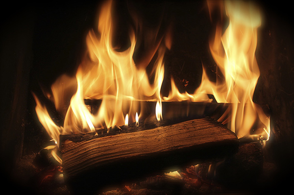 Burning logs in wood-burning fireplace. 