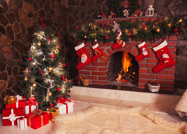 Fireplace with Christmas gifts, stockings and decorations