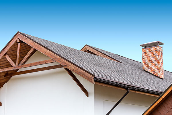 A chimney with a chimney cap on a residential home.