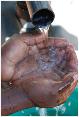 Water pouring into a person's cupped hands.