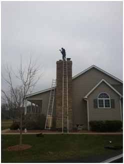 A chimney sweep professional from Doctor Flue inspecting a chimney.