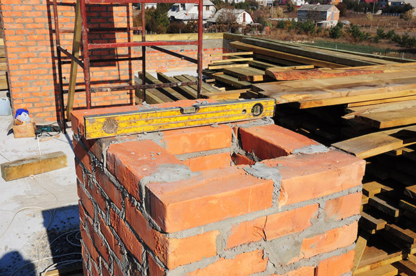 A level resting on a chimney, testing for a leaning chimney problem.