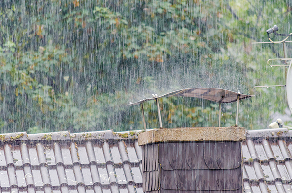 A home chimney in pouring rain