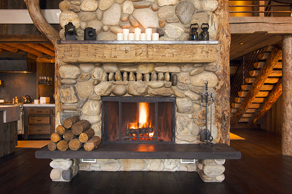 Hearth in a cabin prepared with wood and tools for safely lighting a fireplace