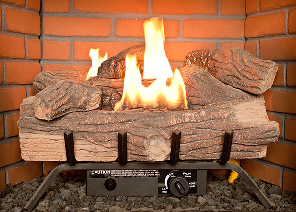 A gas fireplace with gas logs currently burning 