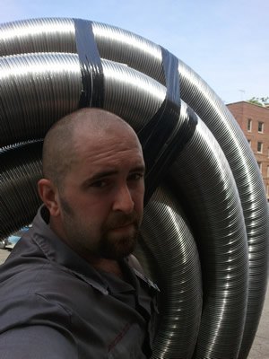Kevon Binder of Doctor Flue carrying a chimney liner
