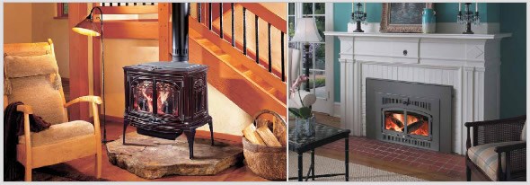 Cast iron wood stove on a stone hearth, beside a wood insert in a white fireplace