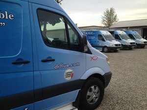 Doctor Flue service trucks parked in a row