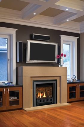 Gas fireplace in a tall cast stone surround below a wall-mounted TV