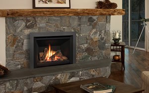 Gas insert in a stacked stone fireplace below a wood beam mantel