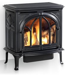 Black cast iron Jøtul gas stove with arched glass doors