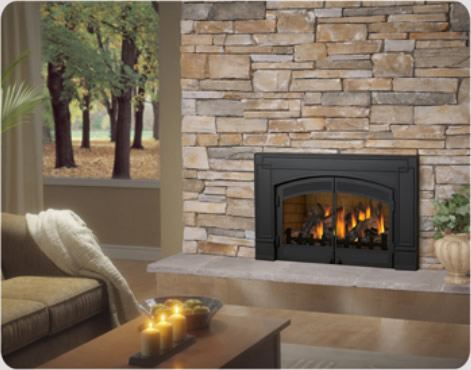 Black gas insert with arched doors in a stacked stone fireplace